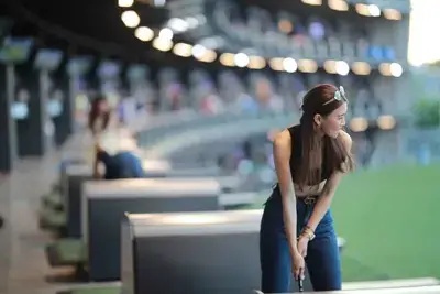 Female golfer enjoying a game at Topgolf