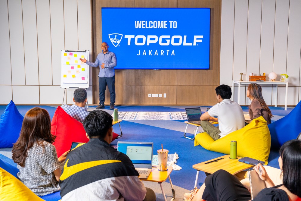 Business meeting taking place at Topgolf